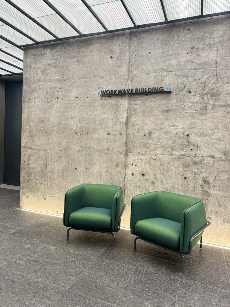 Two green mid-century modern chairs in the Bell Works lobby