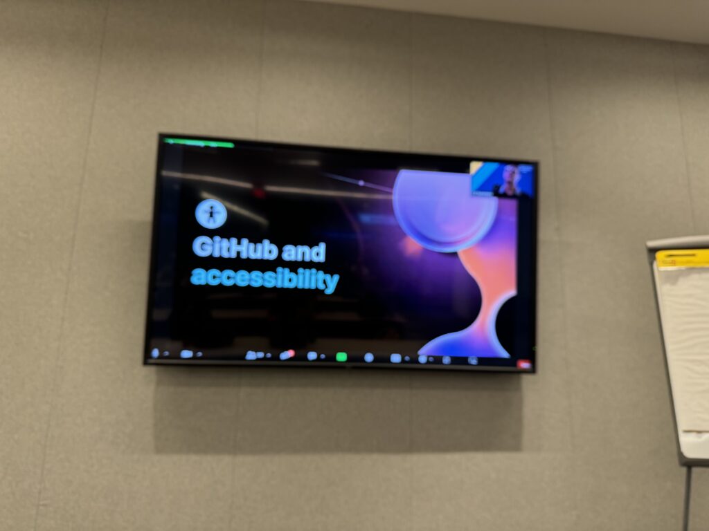 Monitor showing our keynote speakers slide for GitHub and accessibility